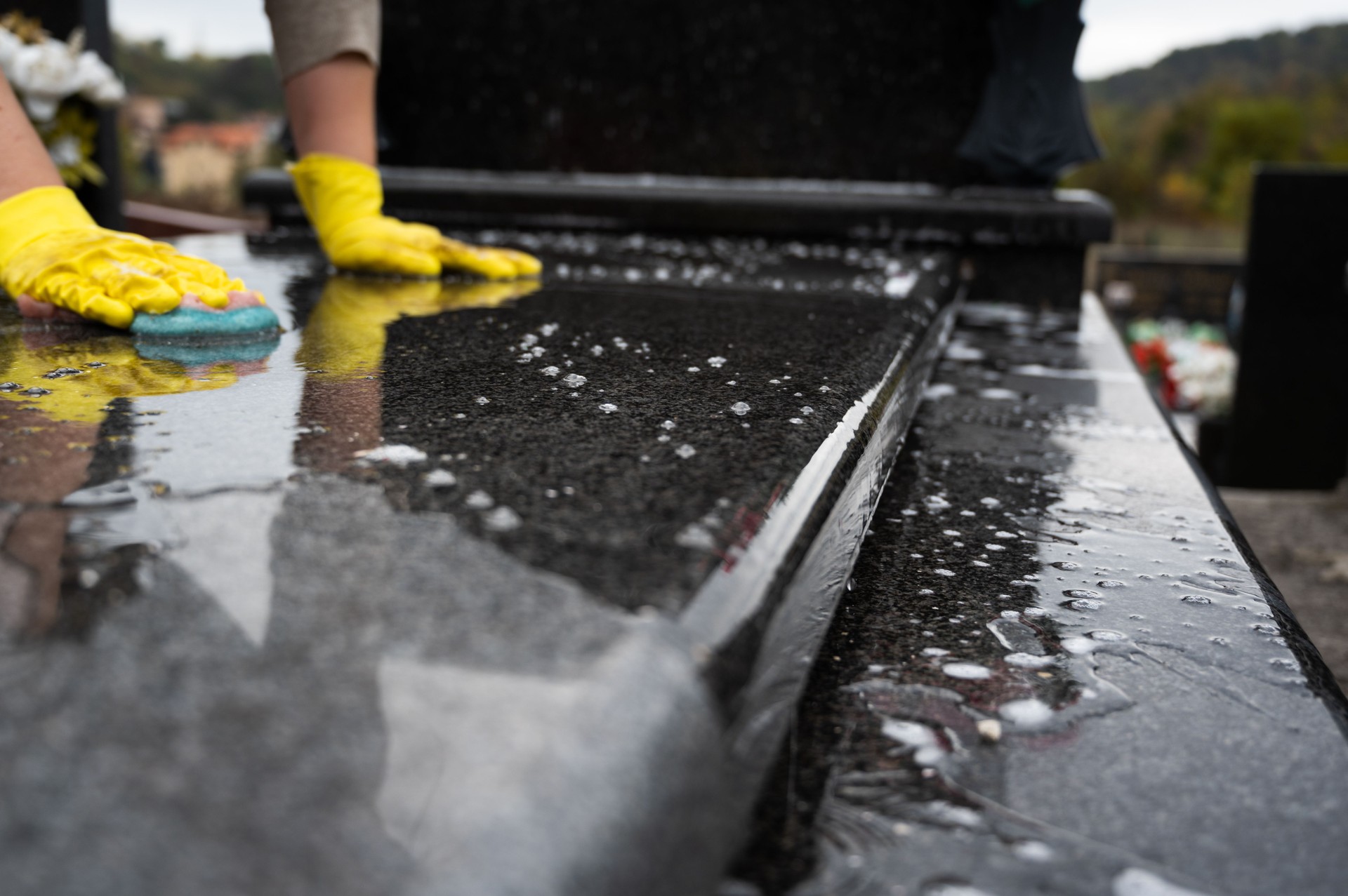 Clean gravestone being gently scrubbed